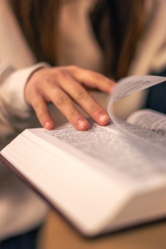 Bible close-up. Christianity concept. Reading the Holy Bible. Bible in women's hands.